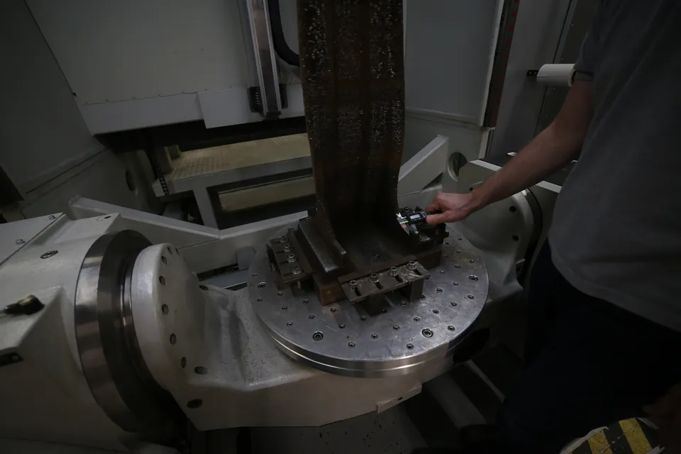 Hohes, schichtweise aufgebautes Metallbauteil auf dem Drehkipptisch